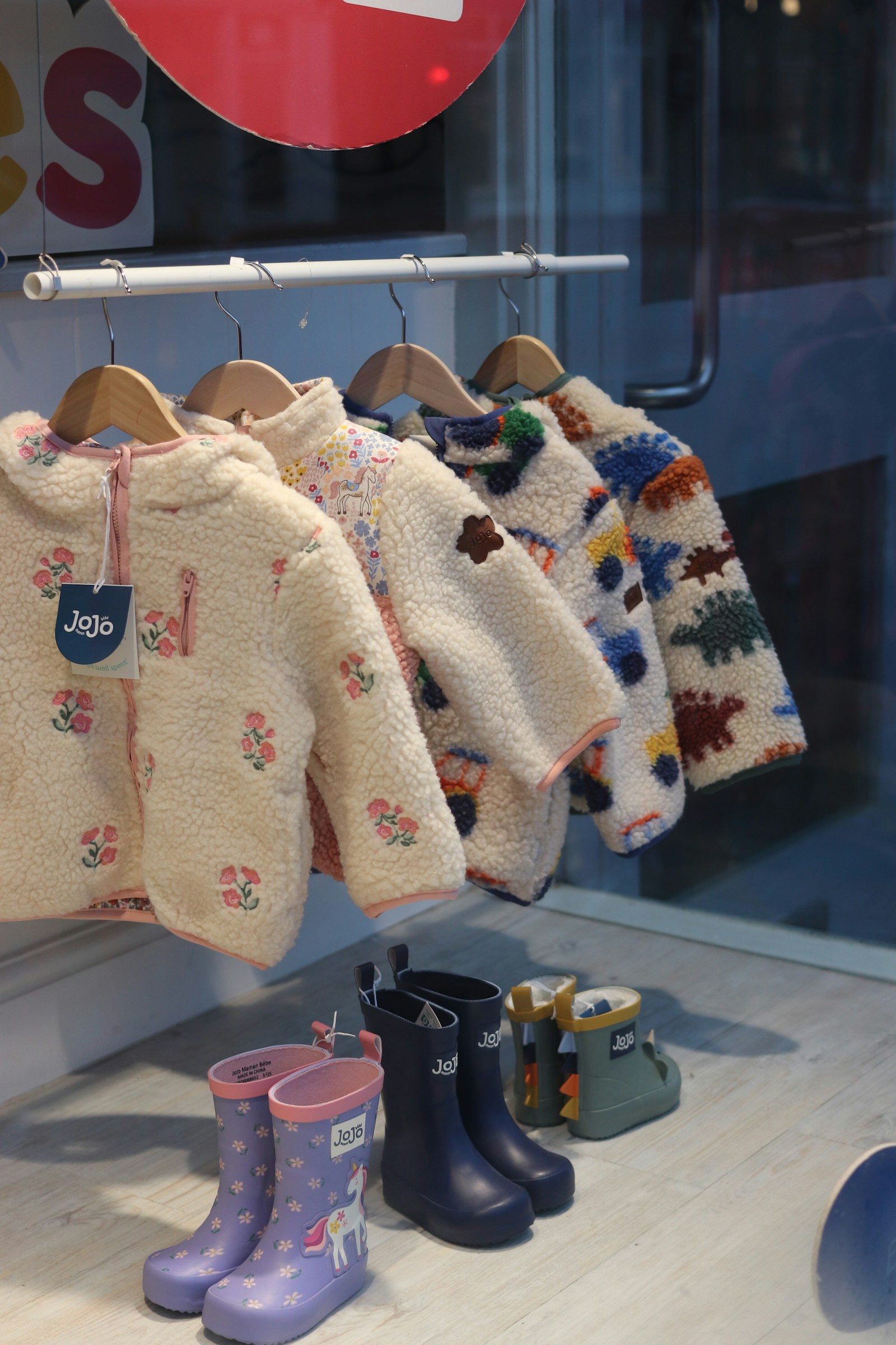 Children's clothing and boots displayed at Forever 9 Closet